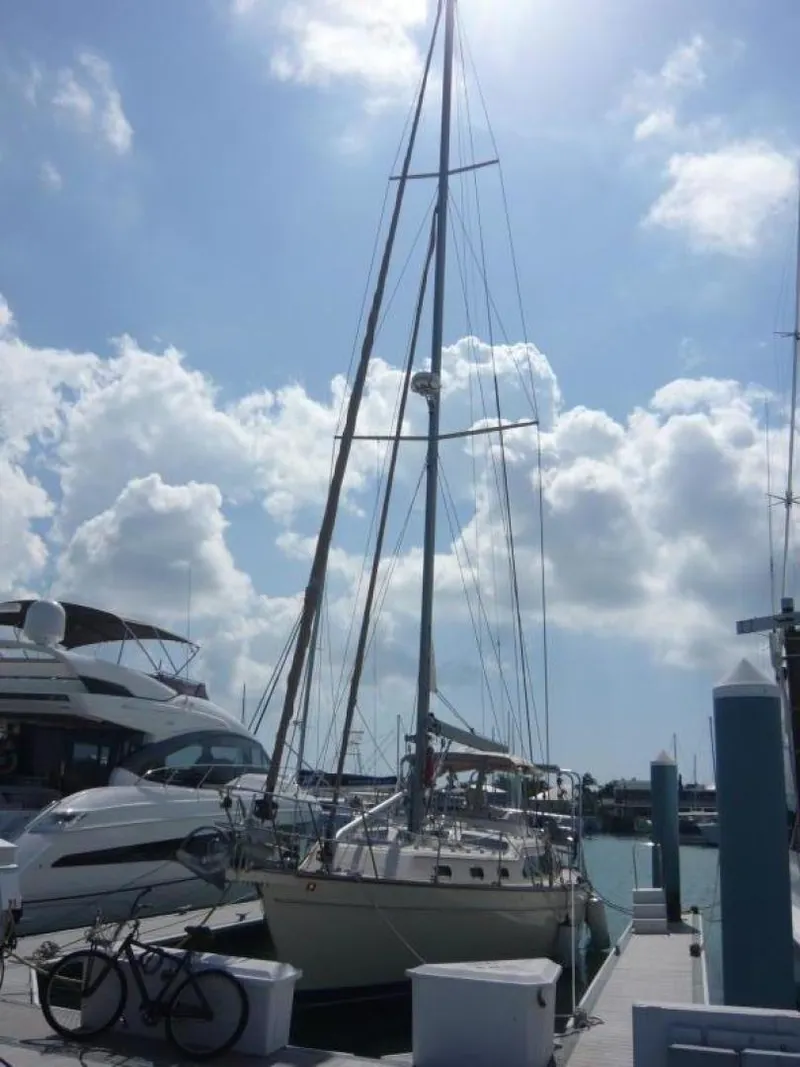 Slide: The Image of 2008 Island Packet 465 sailboat docked under a bright, cloudy sky. - 2
