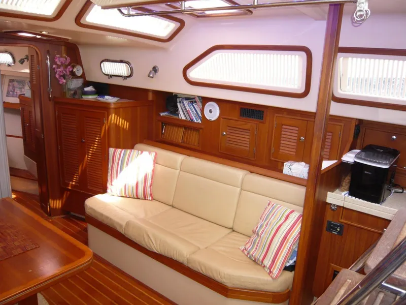 Slide: The Image of Interior of 2008 Island Packet 465 yacht with cozy seating and wooden cabinetry. - 22