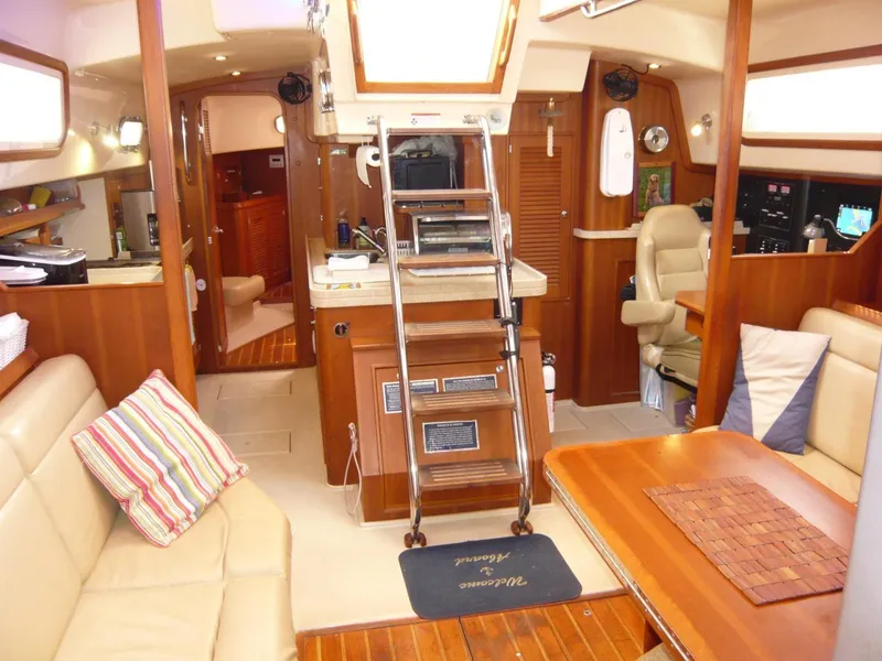 Slide: The Image of Interior of 2008 Island Packet 465 yacht with cozy seating and wooden finishes. - 23