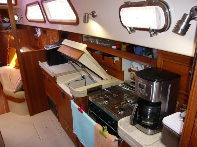 Slide: The Image of Interior of 2008 Island Packet 465 yacht kitchen with stove, sink, and coffee maker. - 25
