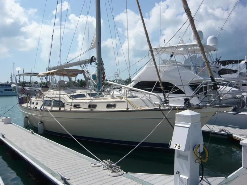 Slide: The Image of 2008 Island Packet 465 sailboat docked at marina under cloudy sky. - 3