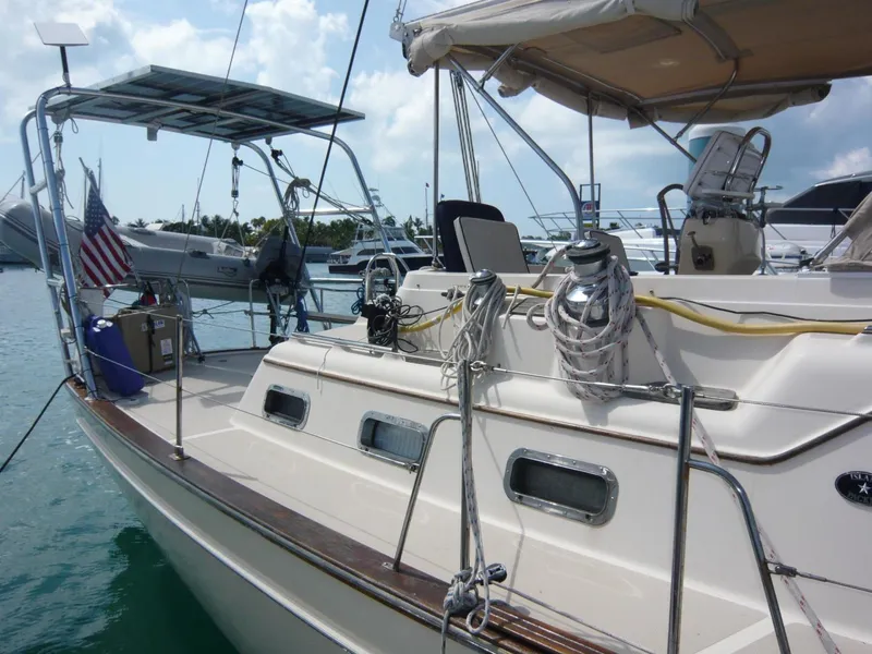 Slide: The Image of 2008 Island Packet 465 sailboat docked, featuring deck equipment and solar panels. - 5