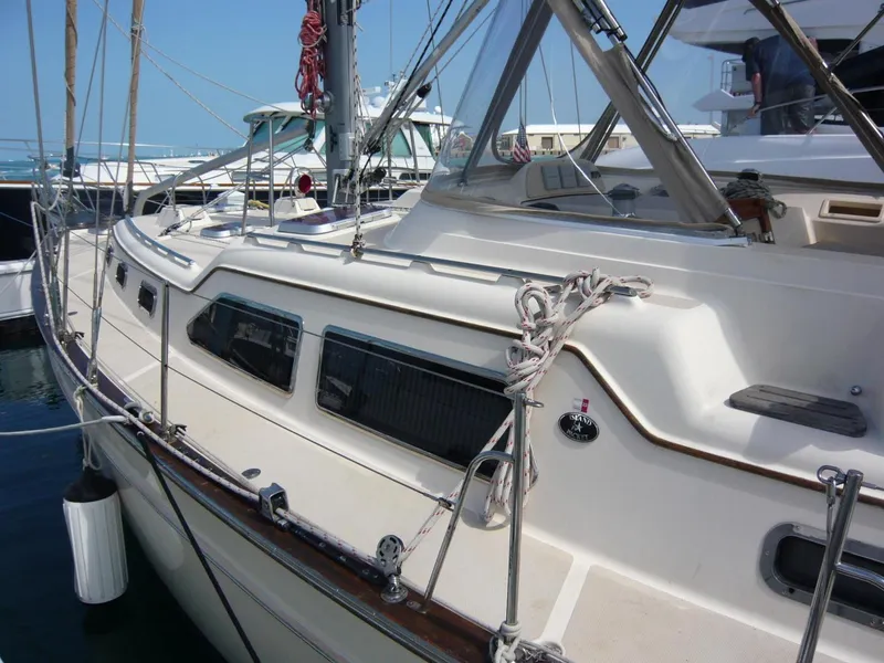 Slide: The Image of 2008 Island Packet 465 sailboat docked at marina, showcasing deck and cabin features. - 6