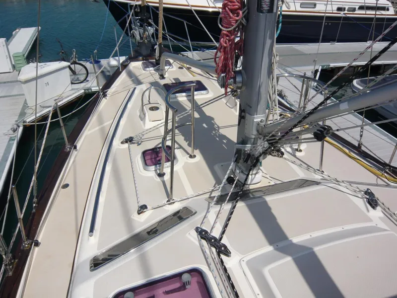 Slide: The Image of 2008 Island Packet 465 sailboat deck with rigging and hatches in marina. - 8