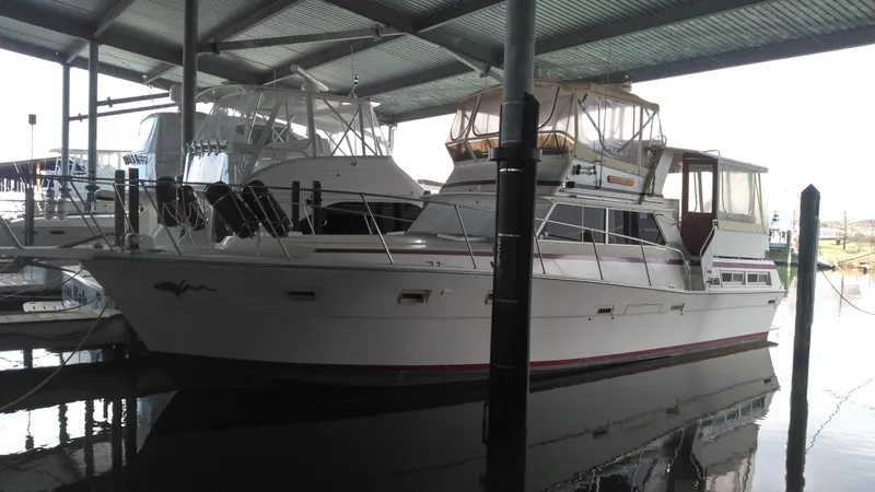 The Image of 1980 Viking 43 Double Cabin yacht docked under a covered marina. - 0