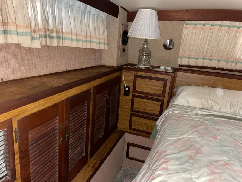 Slide: The Image of Interior of 1980 Viking 43 Double Cabin with wood cabinets and bed. - 12