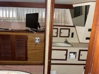 Slide: The Image of 1980 Viking 43 Double Cabin interior with wood cabinetry and small TV. - 14