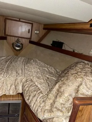 Slide: The Image of Cozy cabin interior of 1980 Viking 43 Double Cabin with patterned bedding. - 16