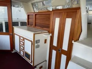 Slide: The Image of 1980 Viking 43 Double Cabin interior with wood paneling and storage cabinets. - 5