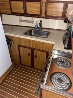 Slide: The Image of 1980 Viking 43 Double Cabin kitchen with wood cabinets, sink, and stove. - 9
