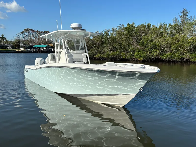 Slide: The Image of 2018 Invincible 33 Open Fisherman boat on calm water, clear sky background. - 1