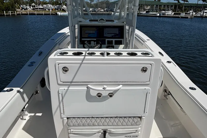 Slide: The Image of 2018 Invincible 33 Open Fisherman boat interior with control panel and rod holders. - 11