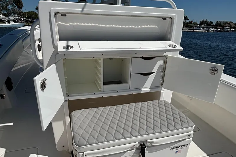 Slide: The Image of 2018 Invincible 33 Open Fisherman boat with open storage and cushioned seating. - 12