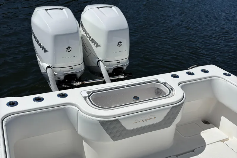 Slide: The Image of 2018 Invincible 33 Open Fisherman with twin Mercury outboard engines on water. - 7