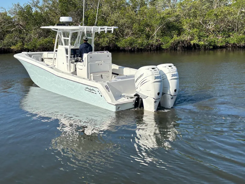 Slide: The Image of 2018 Invincible 33 Open Fisherman boat on calm water, featuring twin engines. - 9