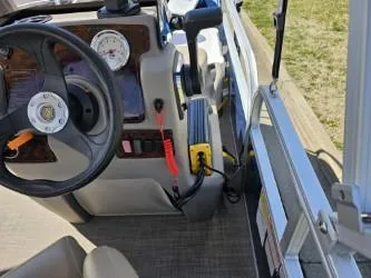 Slide: The Image of 2023 Sun Tracker Bass Buggy 16 XL Select steering console with gauges and controls. - 10