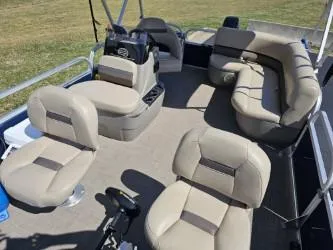 Slide: The Image of 2023 Sun Tracker Bass Buggy 16 XL Select pontoon boat interior with beige seating. - 14