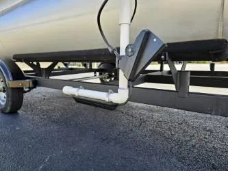 Slide: The Image of 2023 Sun Tracker Bass Buggy 16 XL Select trailer detail, showing undercarriage and wheel. - 6