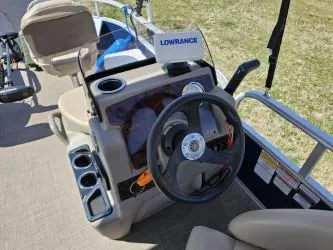 Slide: The Image of 2023 Sun Tracker Bass Buggy 16 XL Select boat dashboard with steering wheel and Lowrance system. - 8