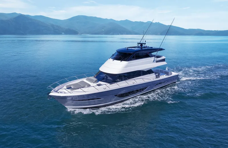 The Image of 2026 Maritimo M600 yacht cruising on serene blue waters with mountainous backdrop. - 1