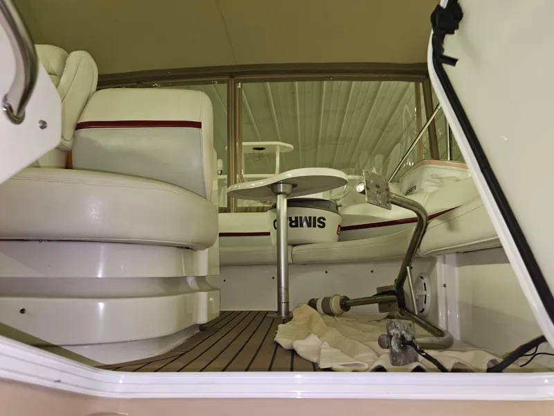 Slide: The Image of Interior view of 2001 Cruisers 5000 Sedan yacht with white seating and wooden flooring. - 14
