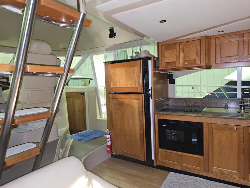 Slide: The Image of Interior of 2001 Cruisers 5000 Sedan yacht with kitchen and seating area. - 21