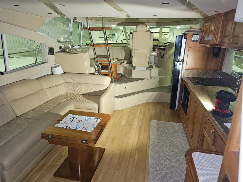 Slide: The Image of Luxurious interior of a 2001 Cruisers 5000 Sedan yacht with leather seating and modern kitchen. - 22