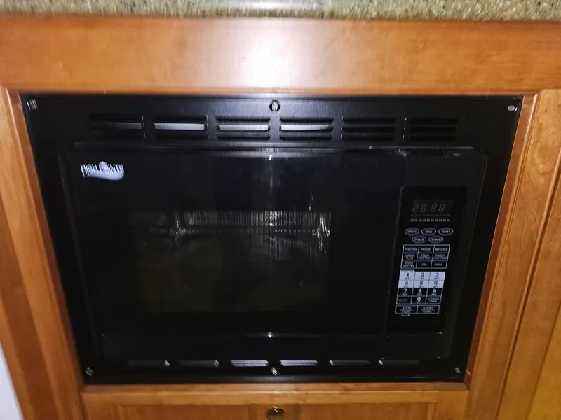 Slide: The Image of Built-in microwave in a 2001 Cruisers 5000 Sedan kitchen area. - 32