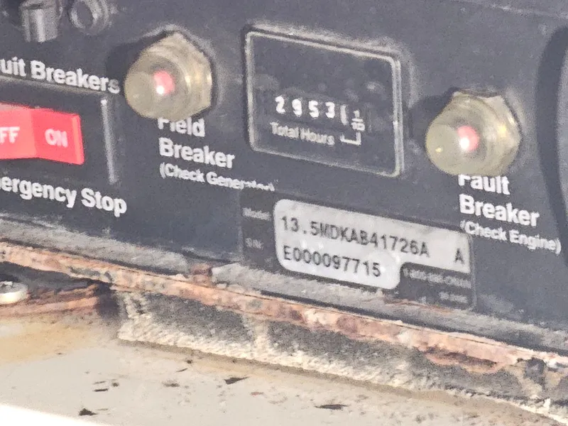 Slide: The Image of Control panel of a 2001 Cruisers 5000 Sedan with hour meter and circuit breakers. - 37