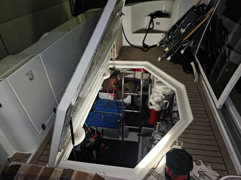 Slide: The Image of Open engine compartment of 2001 Cruisers 5000 Sedan yacht with visible equipment. - 43