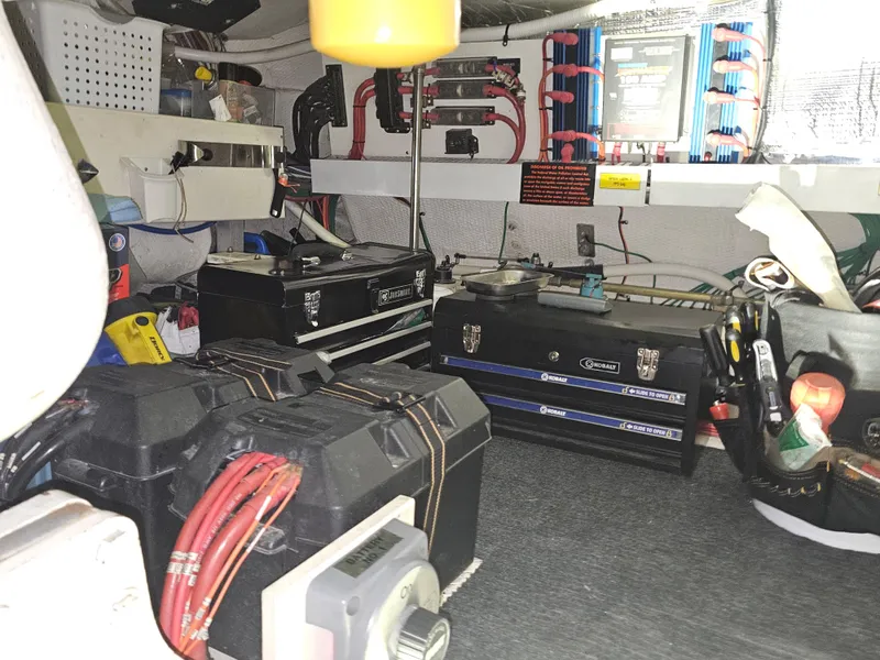 Slide: The Image of Engine room of a 2001 Cruisers 5000 Sedan with tools and electrical components. - 46