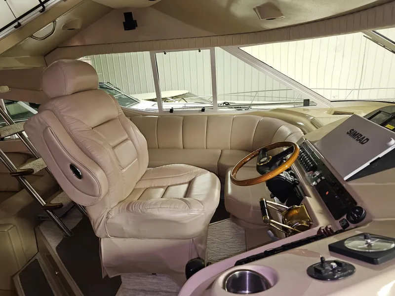 Slide: The Image of 2001 Cruisers 5000 Sedan interior with beige leather seating and wooden steering wheel. - 49