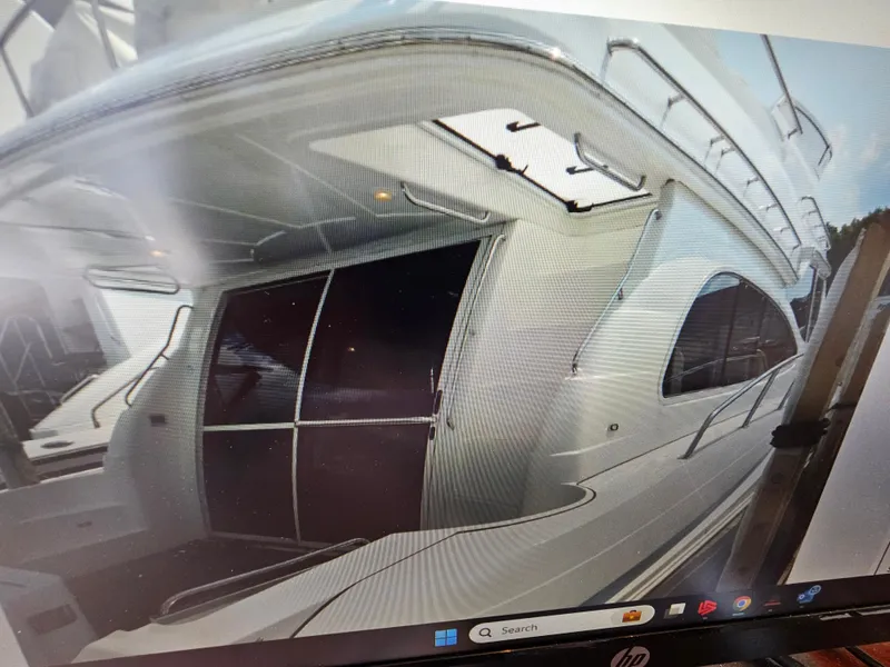 Slide: The Image of 2001 Cruisers 5000 Sedan yacht, exterior view with sleek design and spacious deck area. - 8