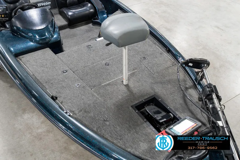 Slide: The Image of 1999 Triton TR-20 boat interior with gray seat and carpeted deck. - 10