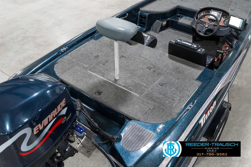 Slide: The Image of 1999 Triton TR-20 boat interior with Evinrude motor, featuring steering console and seating. - 11
