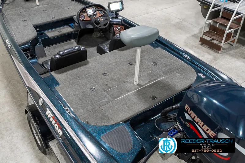 Slide: The Image of 1999 Triton TR-20 fishing boat interior with Evinrude motor and navigation equipment. - 12