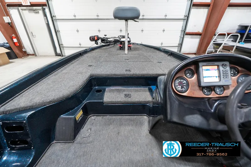 Slide: The Image of 1999 Triton TR-20 boat interior with dashboard and seating, displayed in a garage setting. - 14