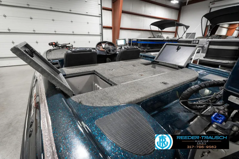 Slide: The Image of 1999 Triton TR-20 boat interior with open storage compartments in a garage setting. - 27
