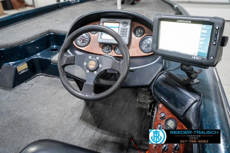 Slide: The Image of 1999 Triton TR-20 boat dashboard with steering wheel and Lowrance HDS display. - 30