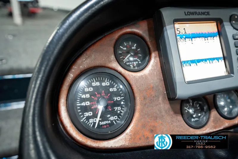 Slide: The Image of Dashboard of a 1999 Triton TR-20 boat with speedometer and Lowrance display. - 33