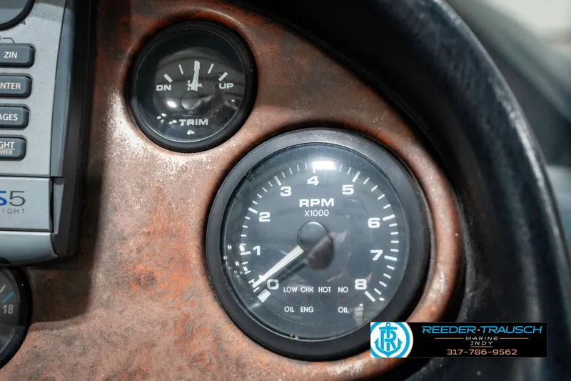 Slide: The Image of 1999 Triton TR-20 dashboard with RPM and trim gauges. - 35