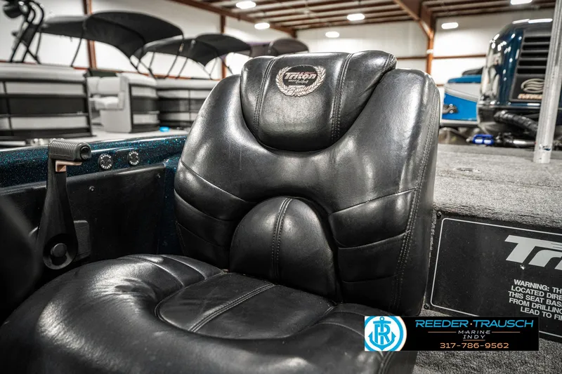 Slide: The Image of Black leather seat in a 1999 Triton TR-20 boat, showroom setting. - 38