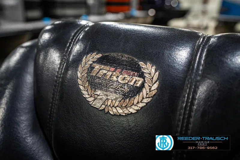 Slide: The Image of Leather seat with Triton TR-20 logo, 1999 model, featuring a laurel wreath design. - 39
