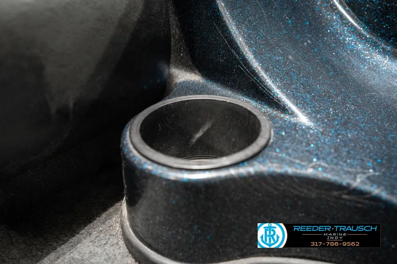 Slide: The Image of Close-up of a 1999 Triton TR-20 boat cup holder with metallic finish. - 41