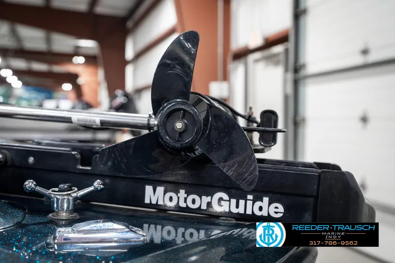 Slide: The Image of Triton TR-20 boat with MotorGuide trolling motor, 1999 model, in a garage setting. - 43