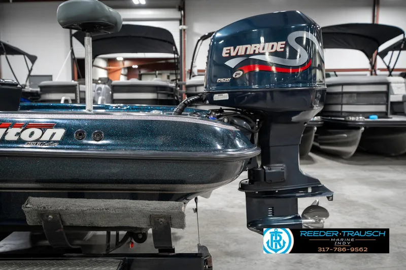Slide: The Image of 1999 Triton TR-20 boat with Evinrude engine in showroom. - 46
