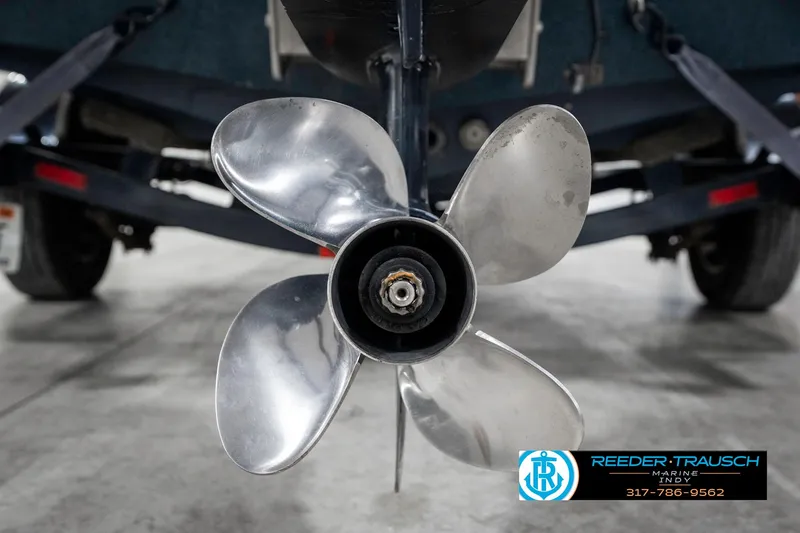 Slide: The Image of 1999 Triton TR-20 boat propeller, close-up view in a garage setting. - 49