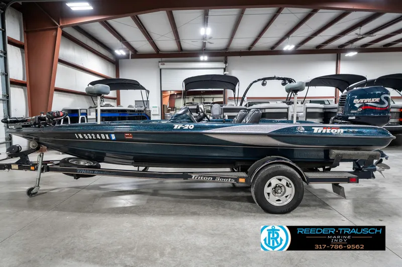 Slide: The Image of 1999 Triton TR-20 boat on trailer in indoor storage facility. - 8