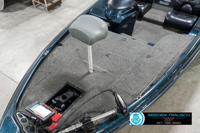 Slide: The Image of 1999 Triton TR-20 fishing boat interior with gray seating and navigation equipment. - 9