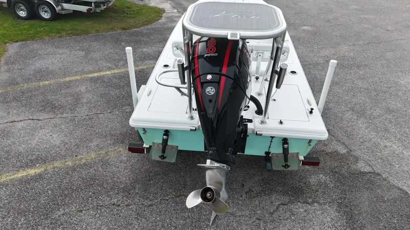 Slide: The Image of 2023 Vtech 18 boat with outboard motor, parked on asphalt. - 11